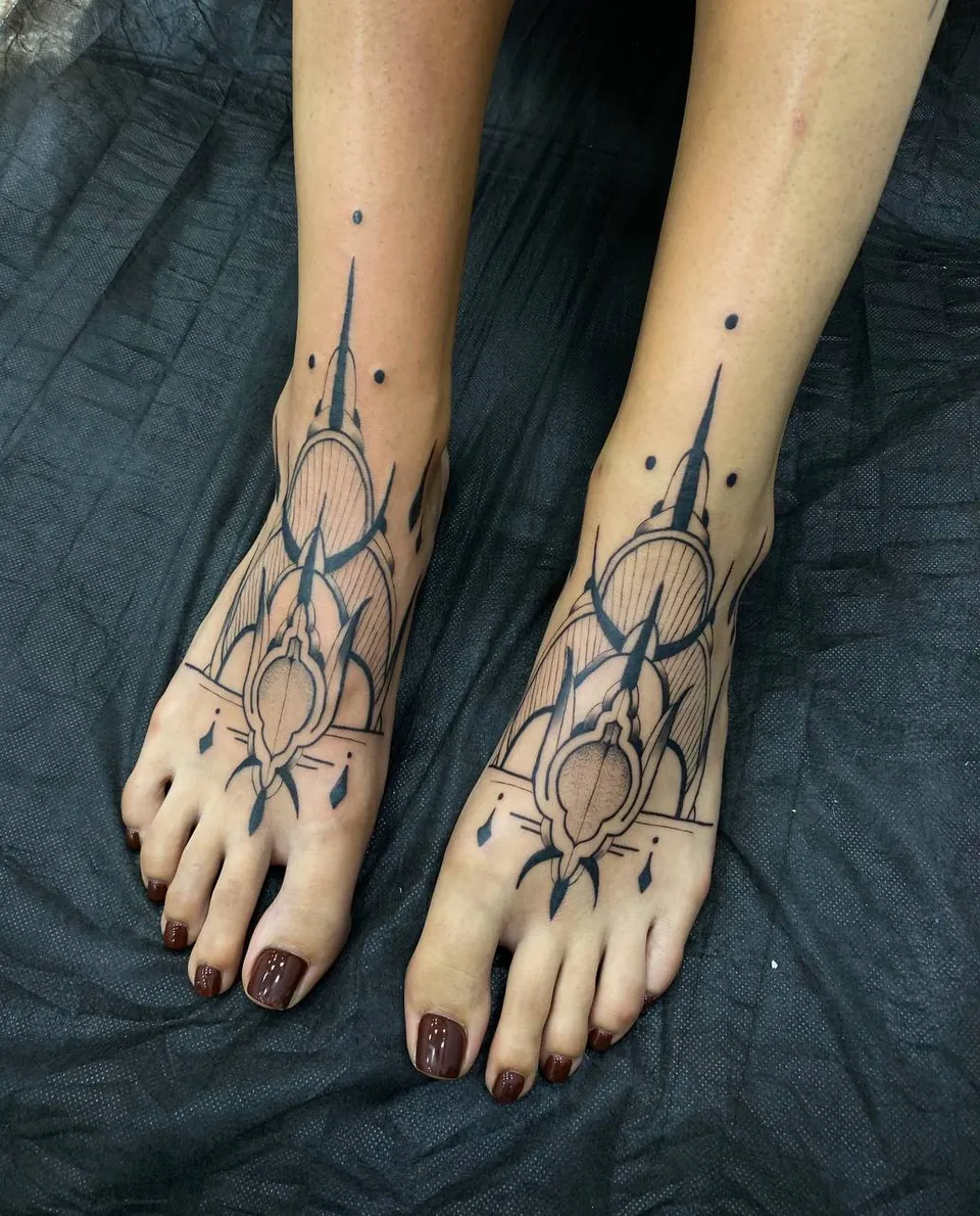 Matching ornamental line tattoos on the tops of both feet